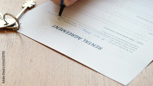 Woman filling a rental agreement form, lease contract. Close up