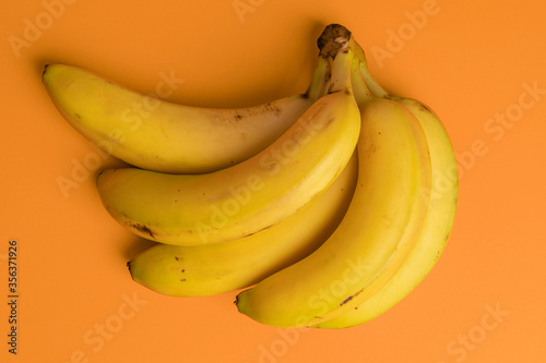 Bunch of ripe bananas on a bright background