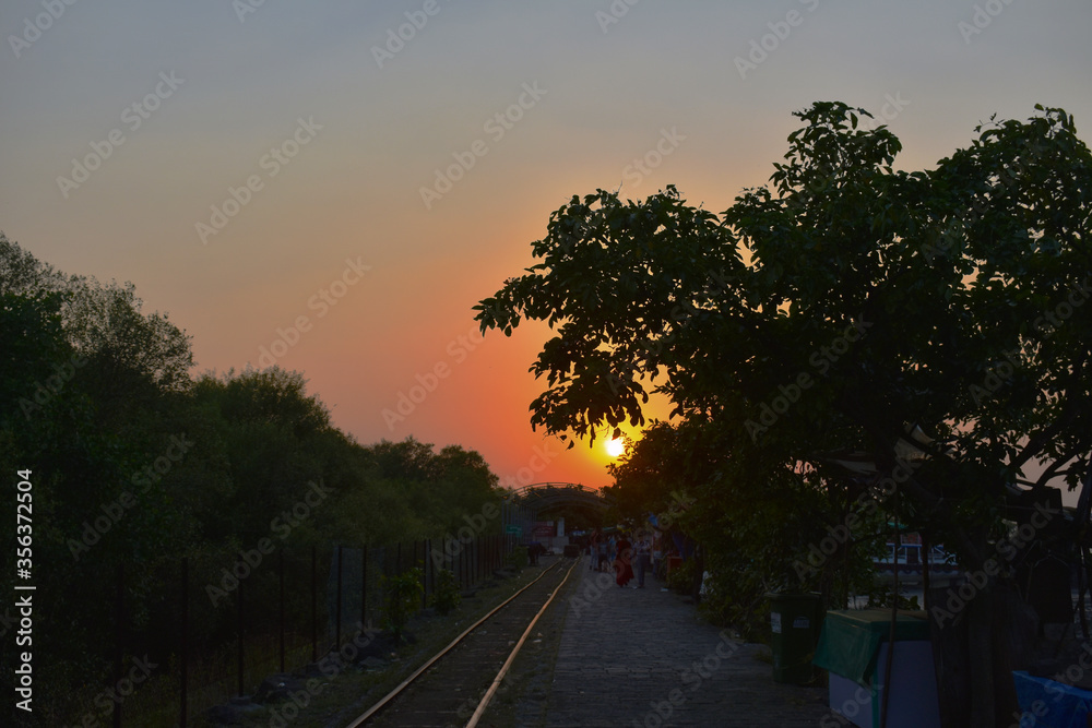 Sunset image captured near Elephanta cave with a rail road following it.