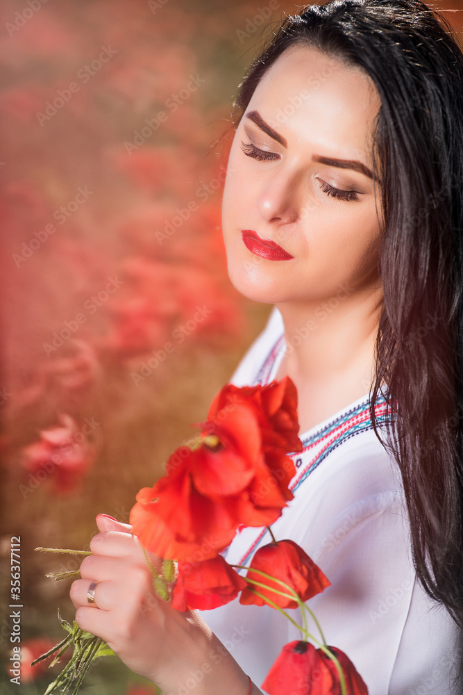Fototapeta premium Young woman on the beautiful poppy field