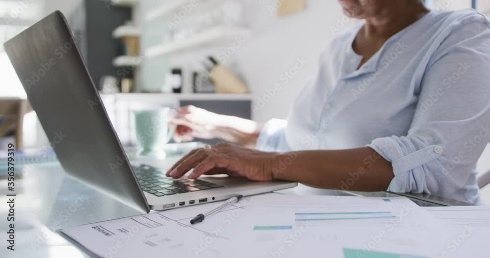 Senior mixed race woman using a laptop. Social distancing and self isolation in quarantine