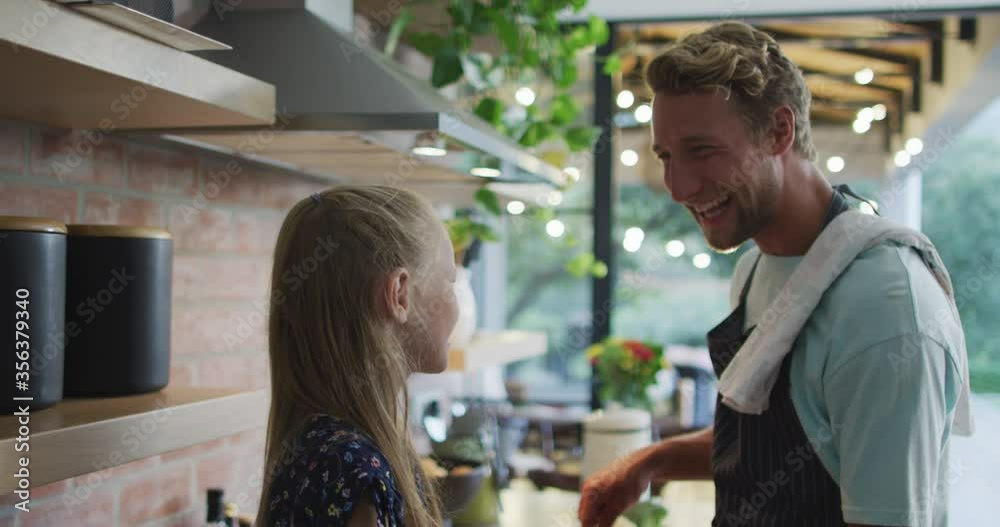 Father and daughter cooking together