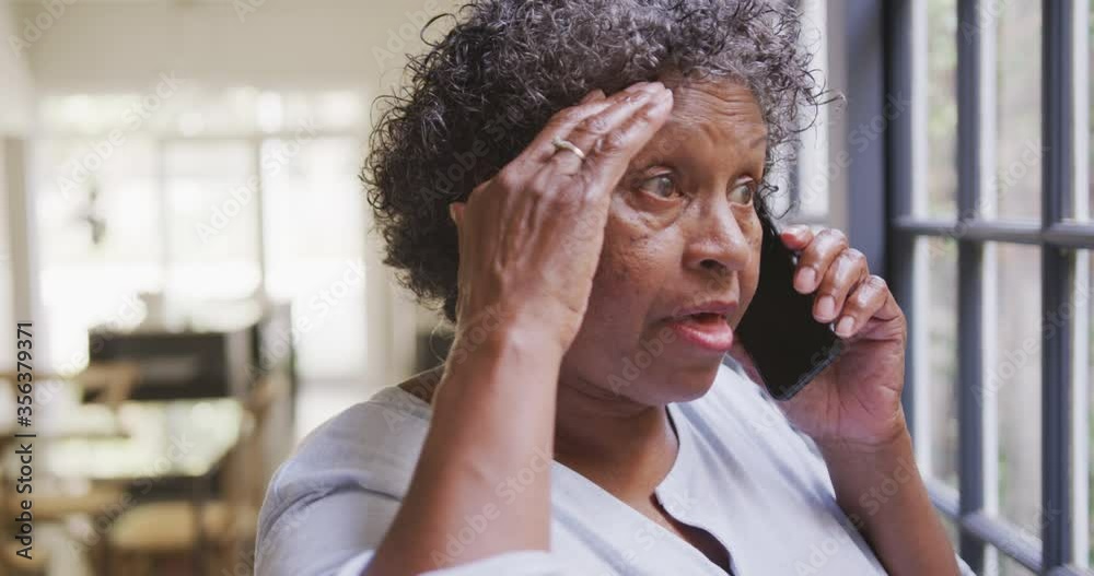 Senior mixed race woman using a smartphone. Social distancing and self isolation in quarantine