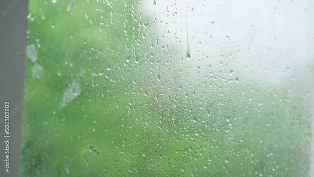 Raindrops run down the glass