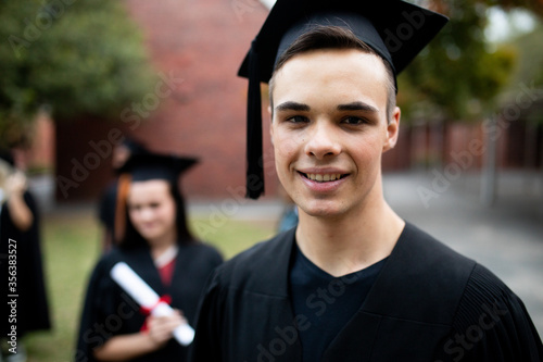 Front view of student graduated looking at the camera