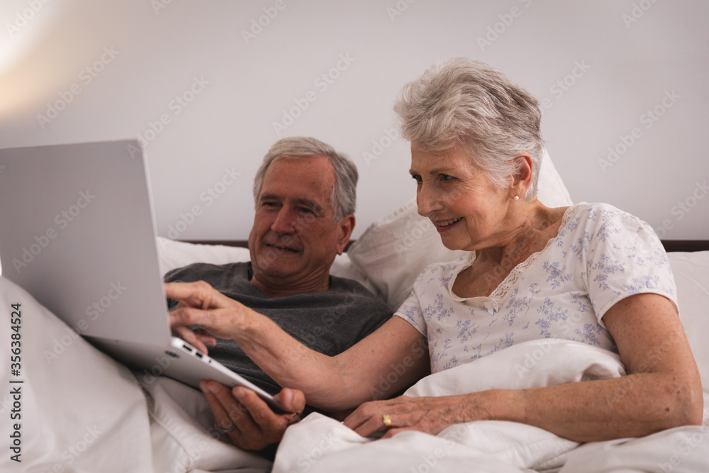 Caucasian senior couple using laptop at home Caucasian senior couple using laptop at home