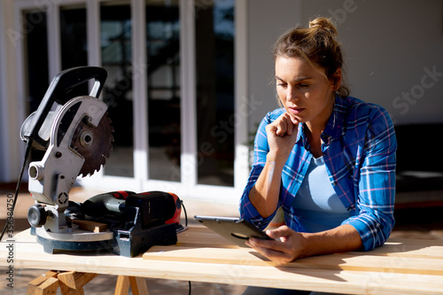 Women in Social Distancing using a digital tablet at home 