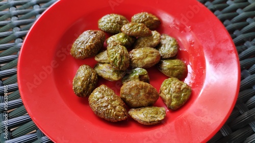 petai goreng or fried petai. typical traditional indonesian food photo