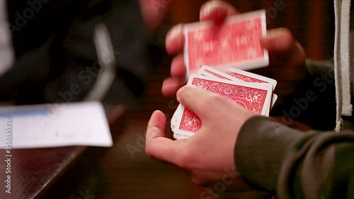 Players male hands interfere, cut and deal cards