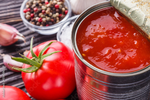 Obraz na plátně juicy canned tomatoes on wooden rustic background