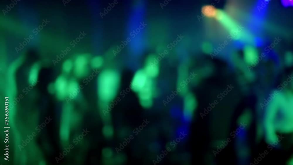blurred silhouettes of a crowd of people dancing on the dance floor in a nightclub blurred silhouettes of a crowd of people dancing on the dance floor in a nightclub