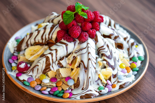 Sweet Waffles with milk chocolate, white chocolate, vanilla cream, strawberries, banana, vanilla ice cream sweet popcorn