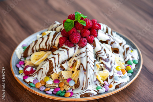 Sweet Waffles with milk chocolate, white chocolate, vanilla cream, strawberries, banana, vanilla ice cream sweet popcorn