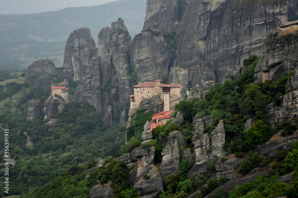 Fototapeta premium Tele view of orthodox monasteries of Meteora (Greece) nestled in a stunning mountain landscape 