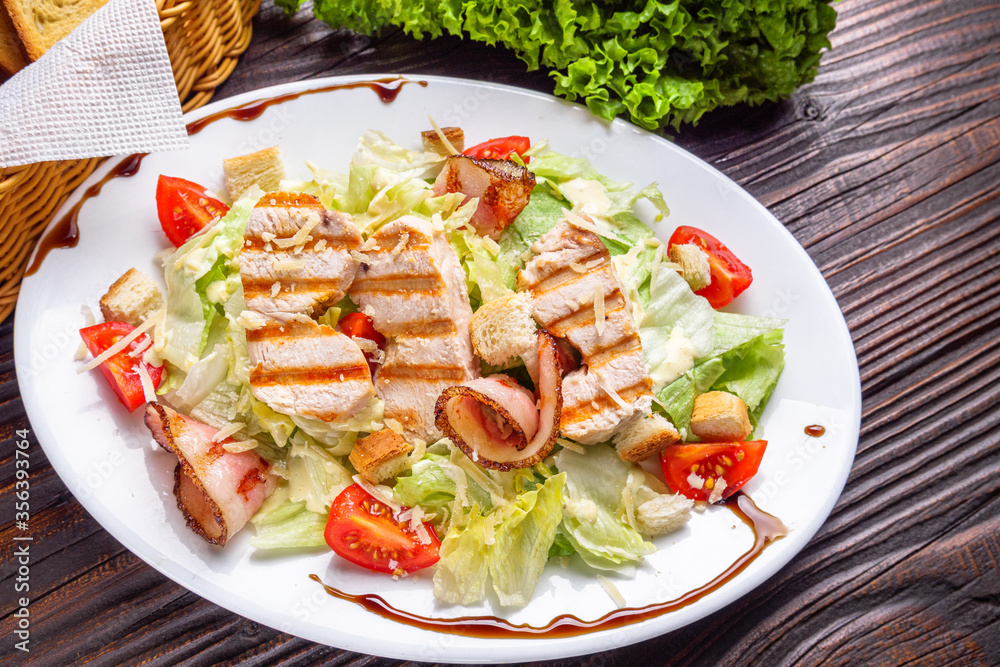 Caesar salad on dark wooden rustic background Caesar salad on dark wooden rustic background