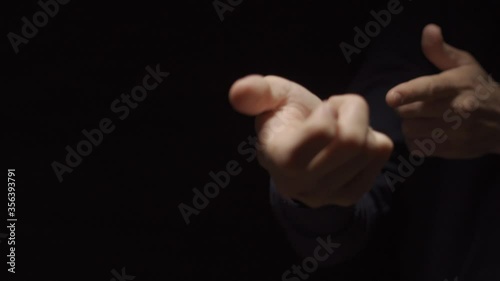 Hand gesture of a shotgun or lethal weapon firearm fires - dark background