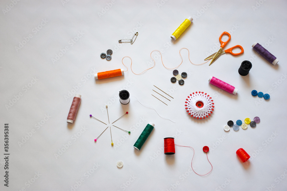 Top view of the sewing tools and accesories on the white background Top view of the sewing tools and accesories on the white background