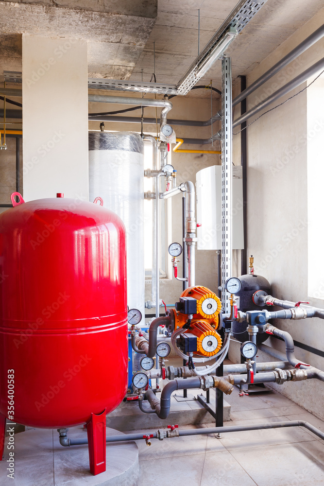 interior of a modern gas boiler room, with a water treatment system, many valves and sensors interior of a modern gas boiler room, with a water treatment system, many valves and sensors
