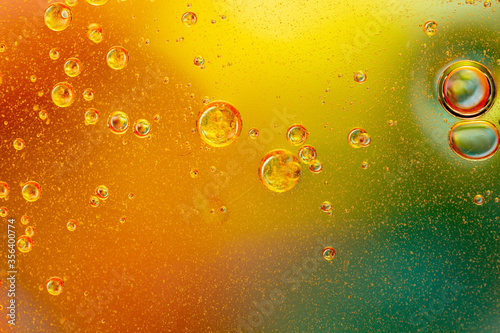 Abstract colorful background with oil drops and waves on water surface