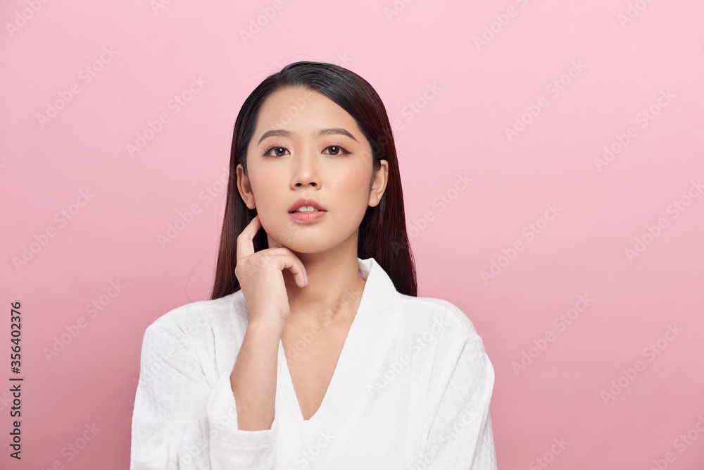 Portrait of beautiful woman with natural make up touching her face Portrait of beautiful woman with natural make up touching her face