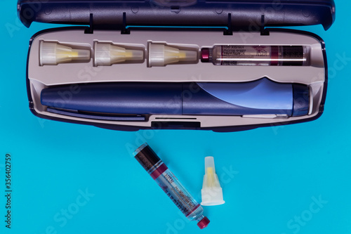 Diabetes. Insulin syringe pen. Ampoules with Insulin. Disposable needles. A healthy lifestyle diabetic. Macro photo. Blue free background. Shymkent, Kazakhstan May 25, 2020