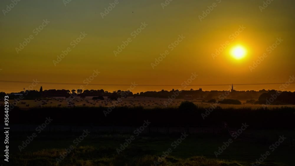 Day to Night Timelaps of the sun setting on a farm in the countryside Day to Night Timelaps of the sun setting on a farm in the countryside