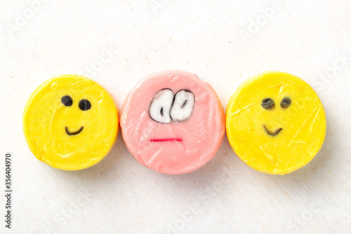 Colorful bright round lollipops with drawn funny faces