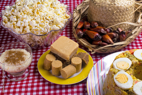 Typical Brazilian junina party food and sweets. Couscouz, peanut candy, sweet rice, dulces de leche and and pine nuts photo