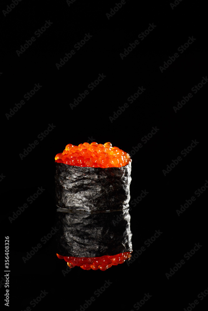 Japanese Cuisine - Appetizing Salmon Sushi Set. Philadelphia Sushi Roll - Maki Sushi with Philadelphia Cheese inside on mirror black background. Smoked salmon rolls served on a plate Japanese Cuisine - Appetizing Salmon Sushi Set. Philadelphia Sushi Roll - Maki Sushi with Philadelphia Cheese inside on mirror black background. Smoked salmon rolls served on a plate