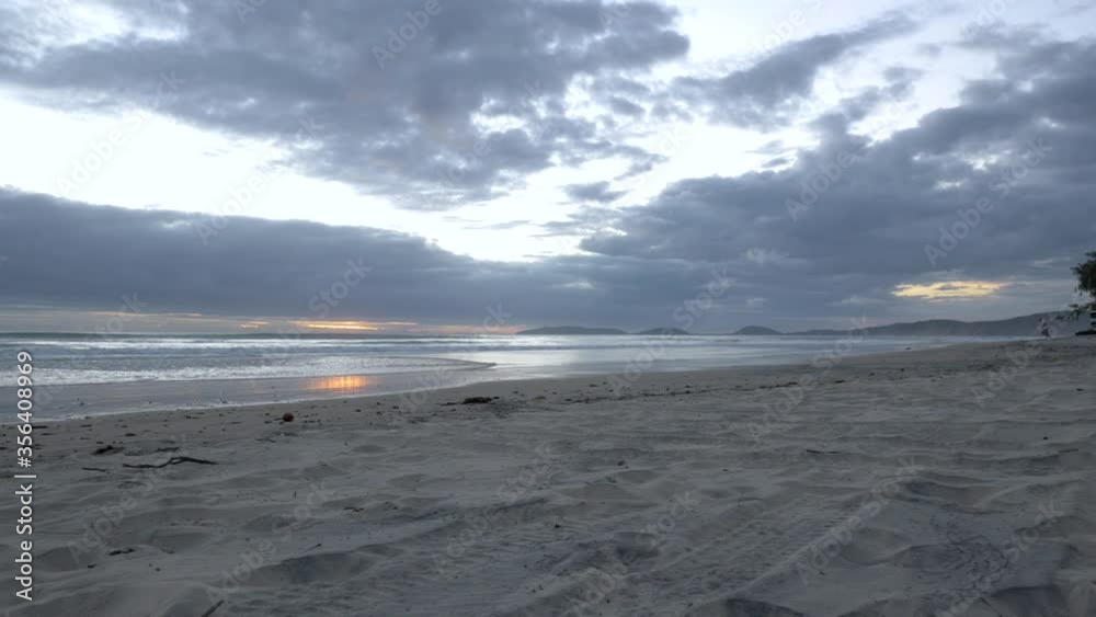 Caucasian man running towards water at sunrise, empty beach, wide angle shot Caucasian man running towards water at sunrise, empty beach, wide angle shot