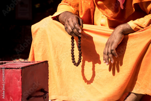 Image of an Indian sadhu sitting in a meditation pose with rudraksha photo