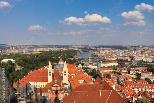 view on the roofs of Prague, the capital of Czech Republic with cloudy blue sky and great view on the Moldova in the center of this picture
