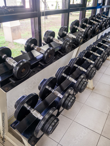 dumbbell set. Close up many metal dumbbells