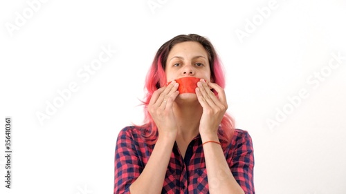 Caucasian beautiful woman seals his mouth with tape in protest. Portrait of a woman with tape on mouth over white background. Prohibition of freedom of speech. Silence