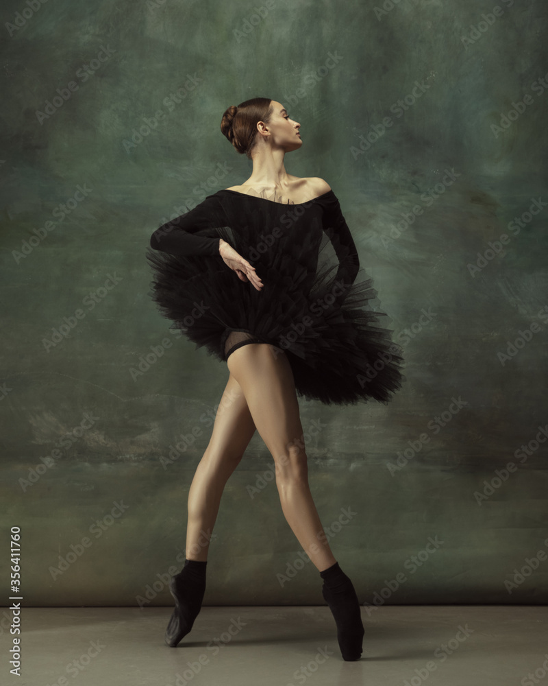 Beautiful portrait. Graceful classic ballerina dancing, posing isolated on  dark studio background. Elegance black tutu. Grace, movement, action and  motion concept. Looks weightless. Fashionable. Photos | Adobe Stock