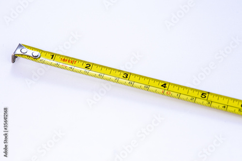 Tape measure closeup with out of focus elements on a white background