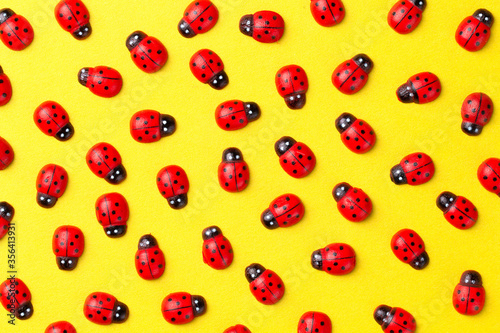 Bright creative colored background with decorative wooden ladybugs