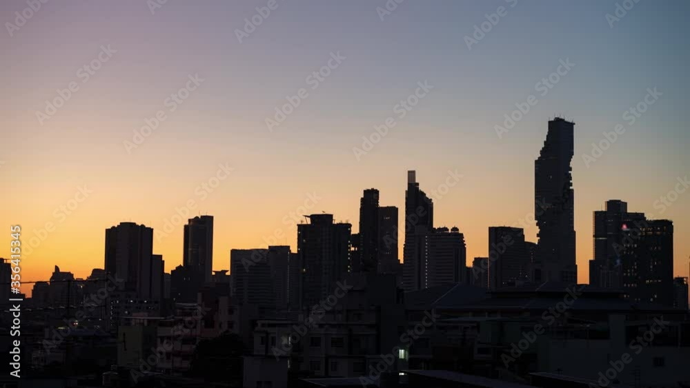 Time lapse of Bangkok skyline sunrise with silhouette of downtown area business office and residential buildings 