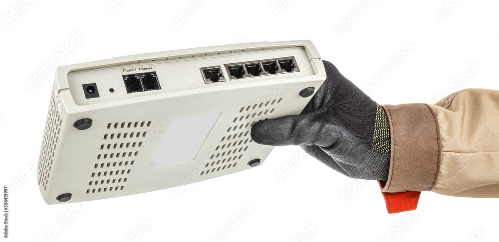 Male hand in black protective glove holding VoIP gateway with connection ports on back panel isolated on white background Male hand in black protective glove holding VoIP gateway with connection ports on back panel isolated on white background