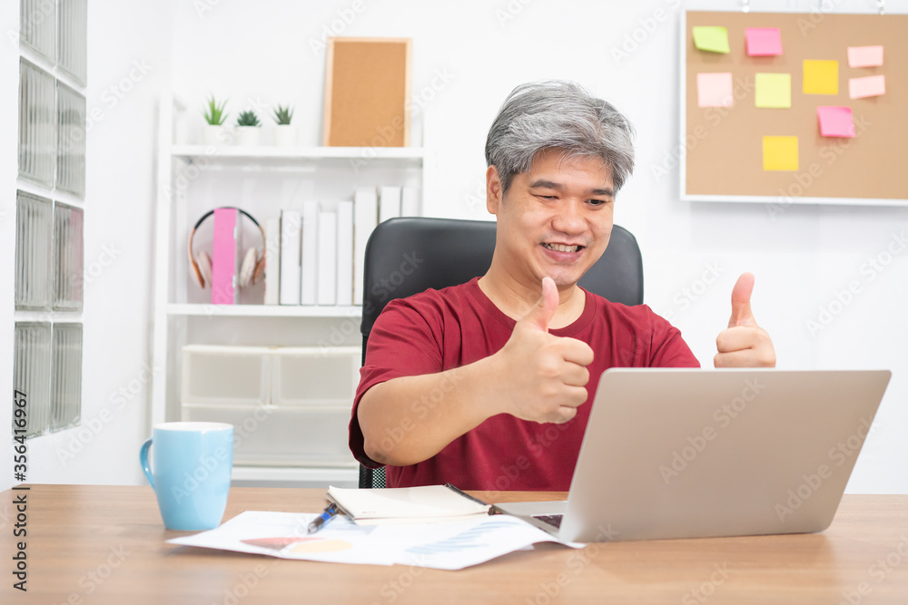 Asian businessman video conference calling on laptop computer talk by webcam for an online learning education course at home. Concept of online education evening study. Asian businessman video conference calling on laptop computer talk by webcam for an online learning education course at home. Concept of online education evening study.