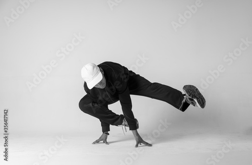 Obraz na plátně A man hip hop dancer or bboy freezes in one pose on a white background