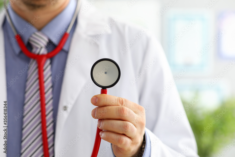 Male medicine doctor hand holding stethoscope head closeup Male medicine doctor hand holding stethoscope head closeup