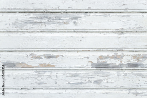 White painted rustic wood planks background with flaking paint. Stavanger, Norway.