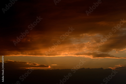 Sunset sky with orange clouds. Nature background.