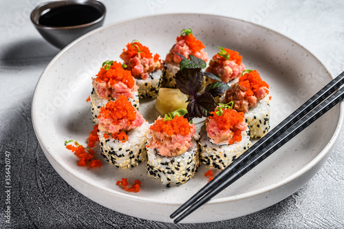 Sushi Maki roll with tuna, salmon and caviar. Gray background. Top view.