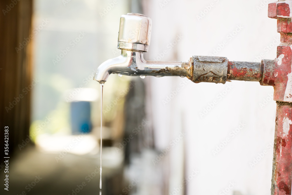 Image of water from a tap in a hilly mountain areas with save water concept