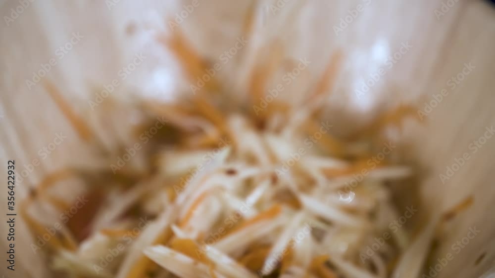 Squeezing Fresh Green Lime on Som Tum Papaya Salad - Close Up Squeezing Fresh Green Lime on Som Tum Papaya Salad - Close Up