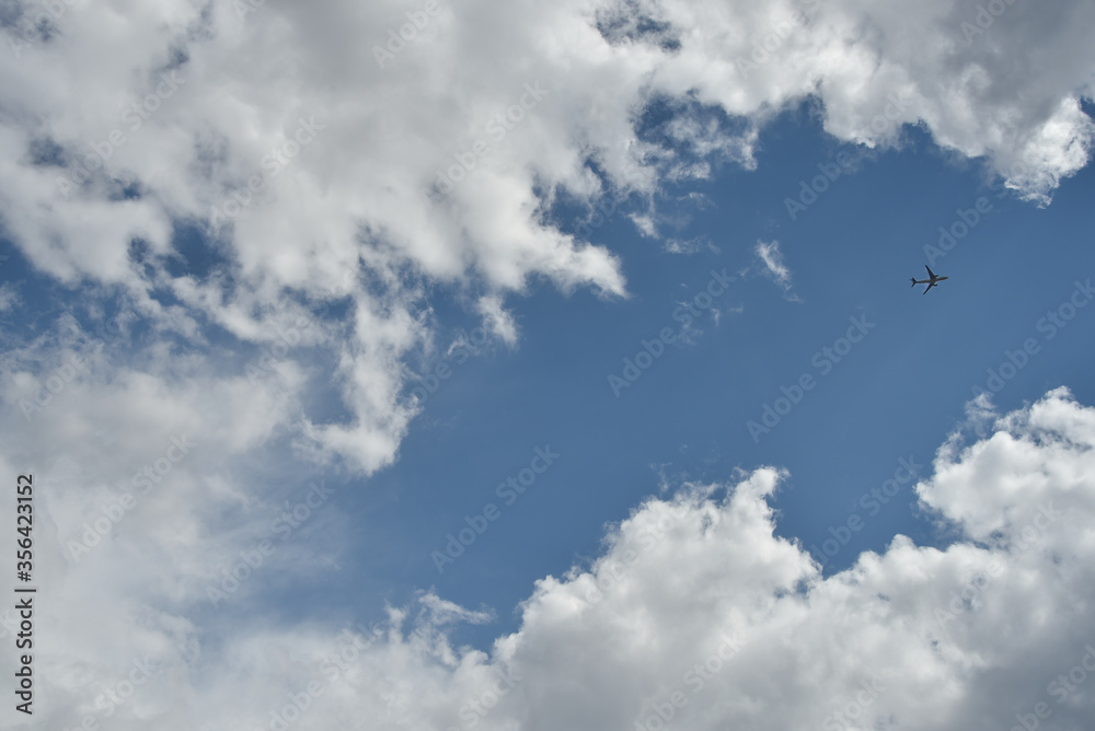 Plane flying through clouds in the sky. aircraft in the air Plane flying through clouds in the sky. aircraft in the air