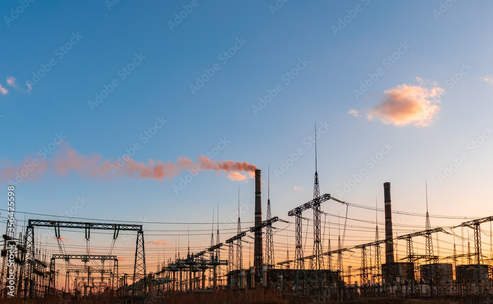 Thermal power stations and power lines during sunset.
