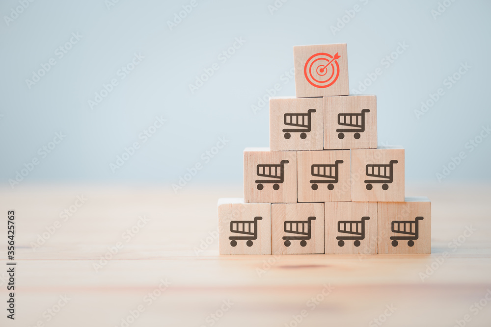 Sale volume increase make, business success grow wood cube with icon shopping cart and target goal. Goal setting idea to increase sales successfully. Sale volume increase make, business success grow wood cube with icon shopping cart and target goal. Goal setting idea to increase sales successfully.